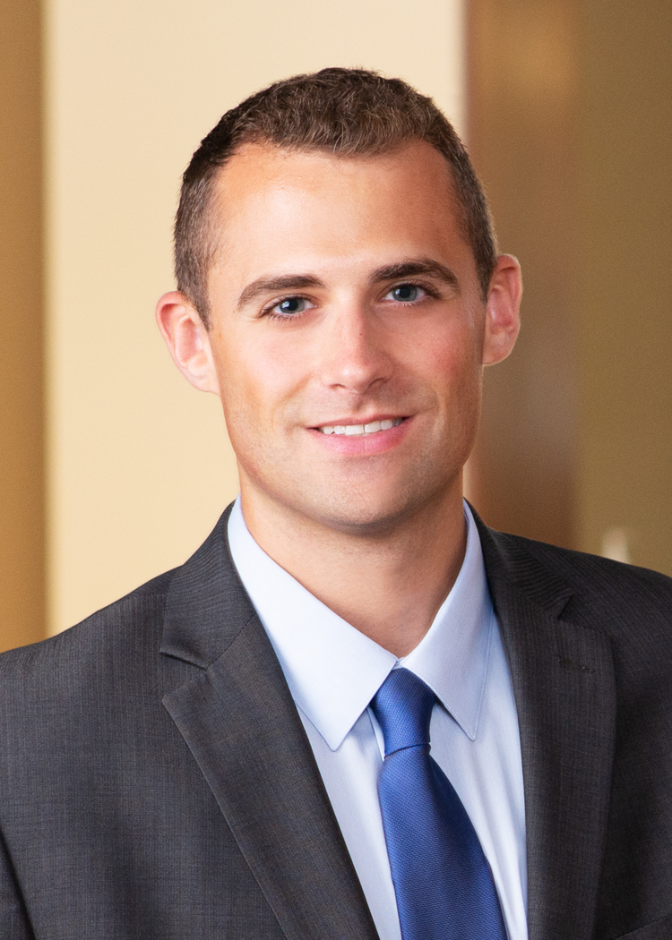 Professional head shot of Robert Turchick in a suit standing in an office