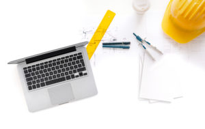 Architect drawing blueprint. High angle view.