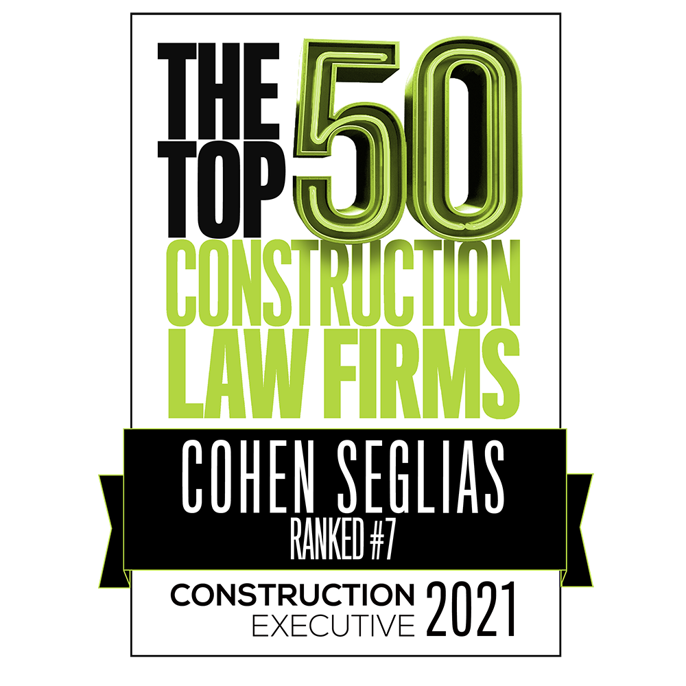 The top 50 construction law firm sign written in black and green with black ribbon around lower half