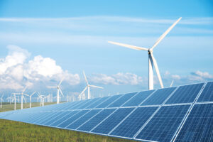 solar panel in green lawn with wind power station in blue sky