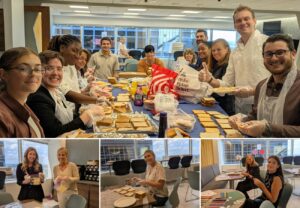 Collage of photos highlighting a Cohen Seglias community service event. The main image shows employees and summer associates wearing gloves and aprons while assembling peanut butter and jelly sandwiches around a long table filled with bread, sandwich ingredients, and supplies. Three smaller images below show volunteers packaging sandwiches and creating handmade placemats for donation recipients in the firm's office.